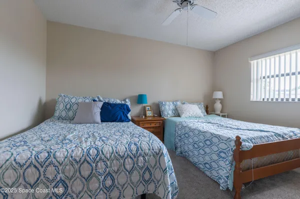 a bedroom with double bed and a window