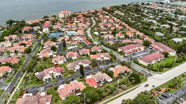 an aerial view of residential houses with yard