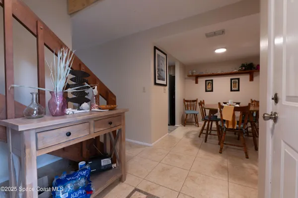 a view of dining table chairs and entryway