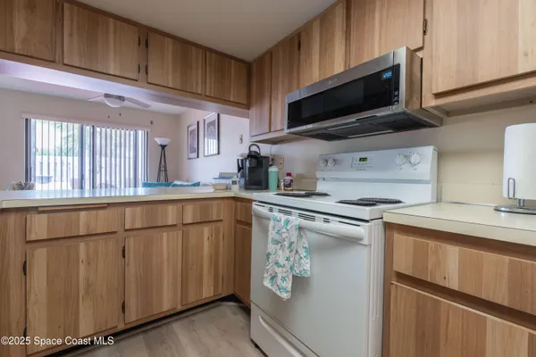 a kitchen with stainless steel appliances a stove microwave and a sink