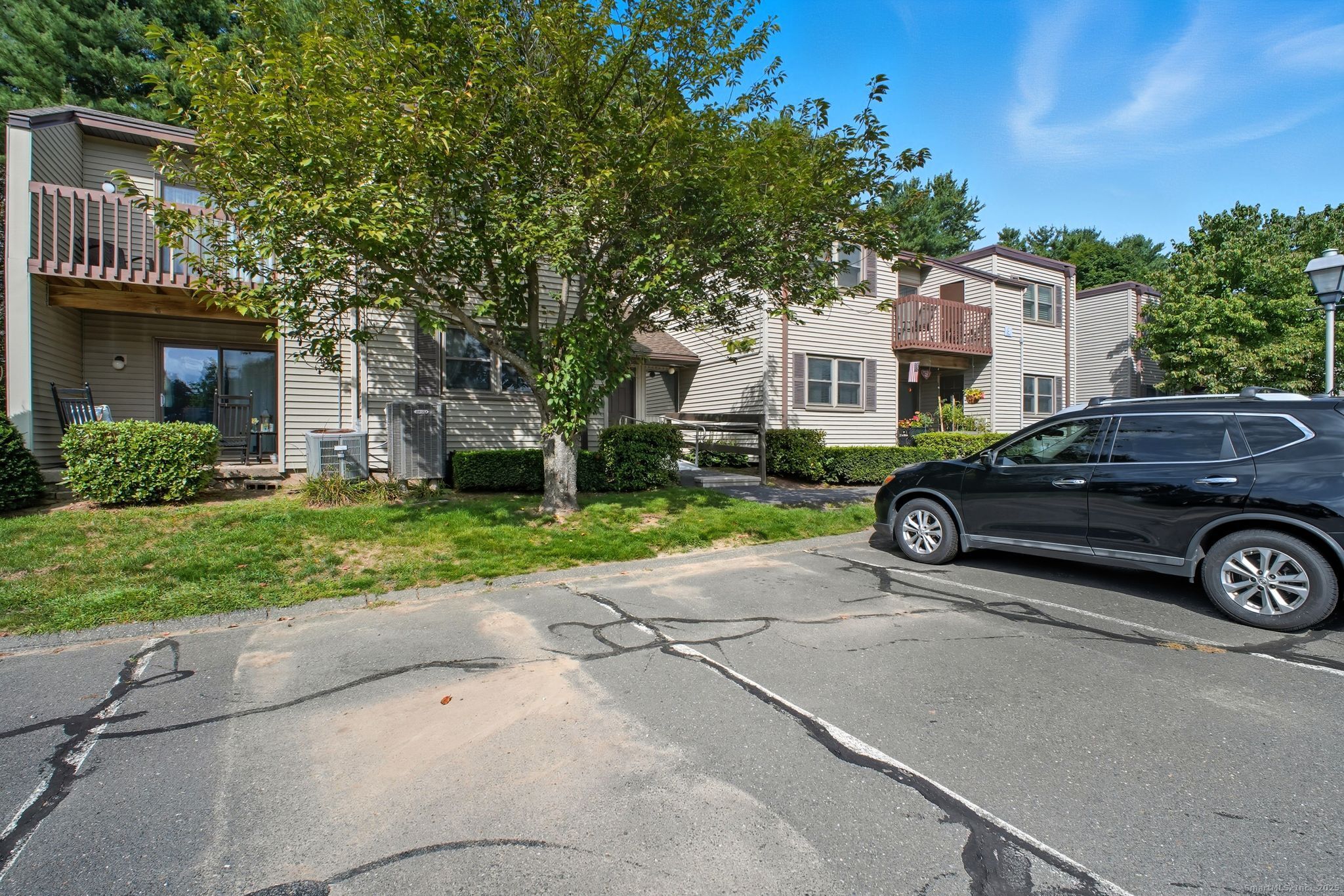 402 Twin Circle Drive, Unit 402 South Windsor, CT 06074 - Photo 16 of 18 a car parked in front of a house