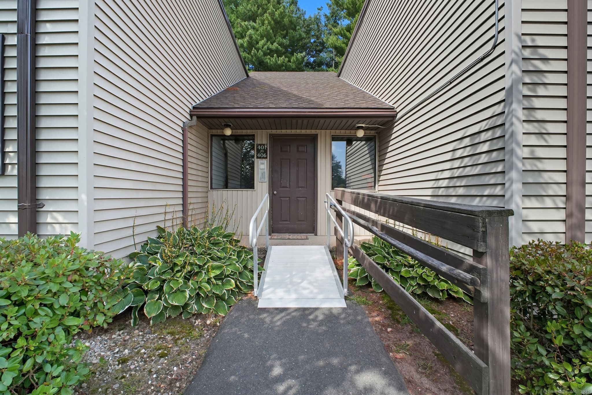 402 Twin Circle Drive, Unit 402 South Windsor, CT 06074 - Photo 2 of 18 a front view of a house with garden