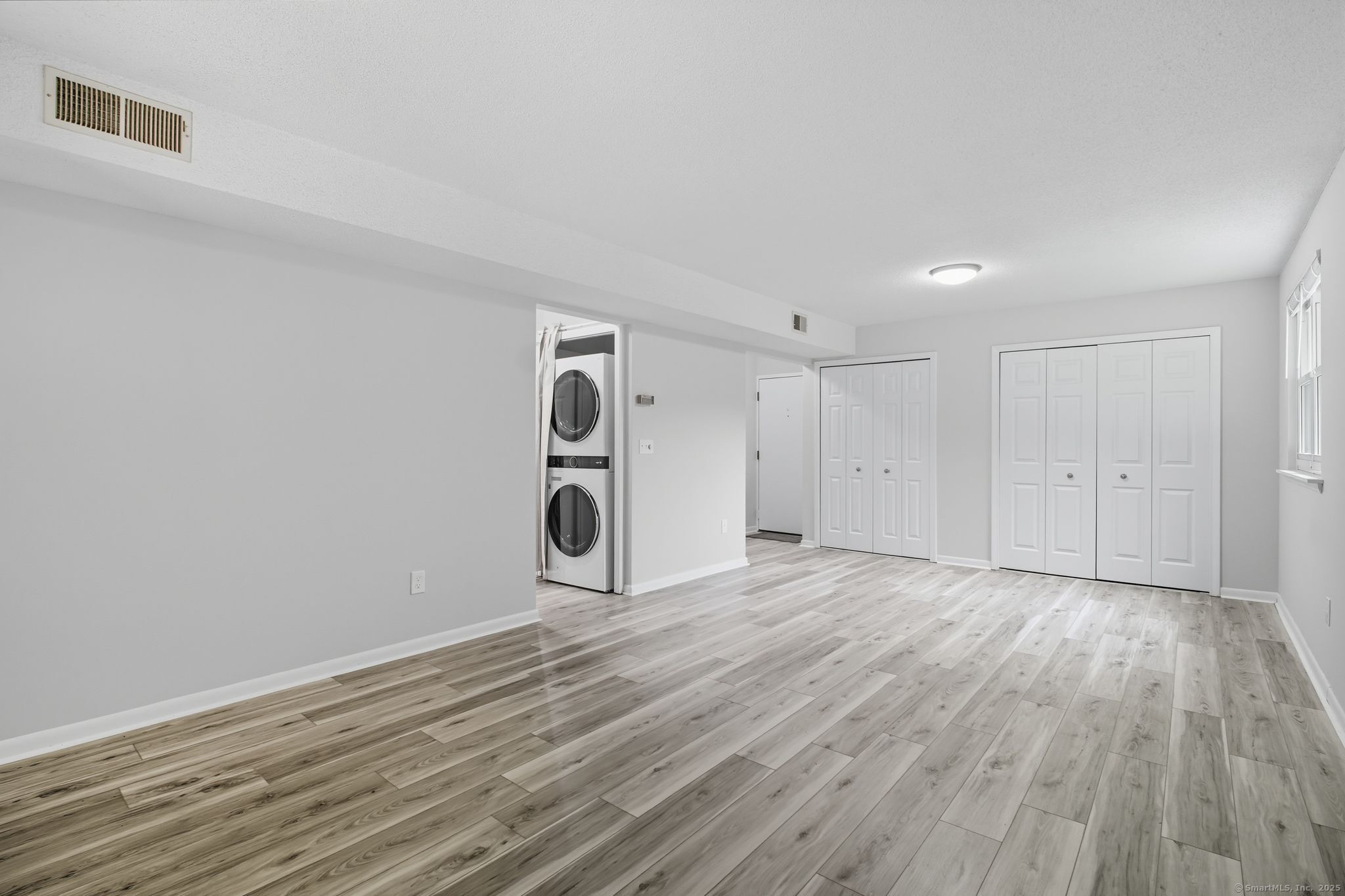 402 Twin Circle Drive, Unit 402 South Windsor, CT 06074 - Photo 6 of 18 a view of empty room with wooden floor and window