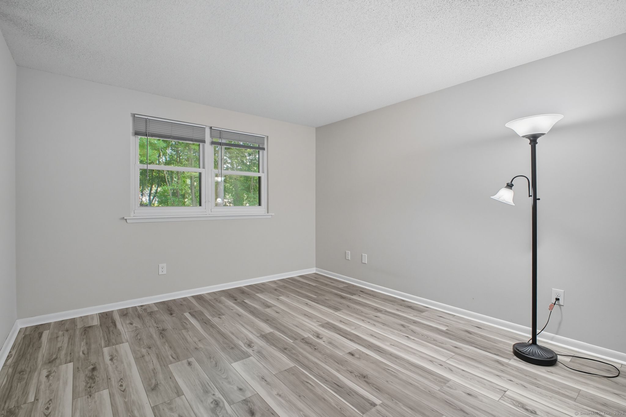 402 Twin Circle Drive, Unit 402 South Windsor, CT 06074 - Photo 9 of 18 a view of an empty room with wooden floor and a window