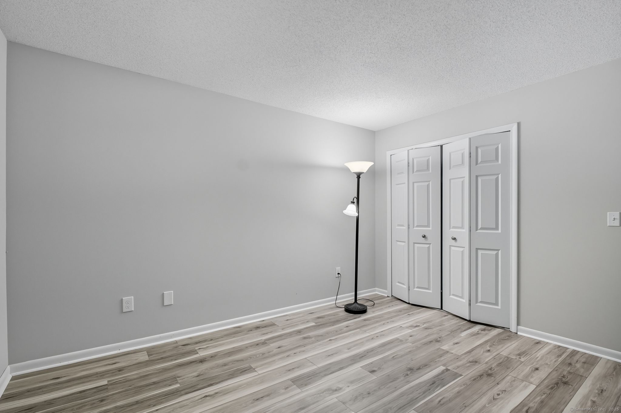 402 Twin Circle Drive, Unit 402 South Windsor, CT 06074 - Photo 10 of 18 a view of an empty room with wooden floor