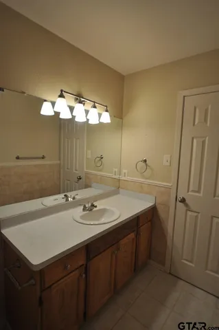 a bathroom with a sink a vanity and a mirror