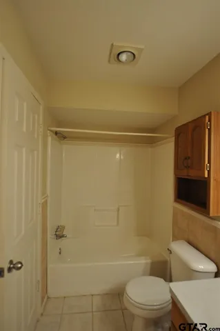 a bathroom with a toilet and shower