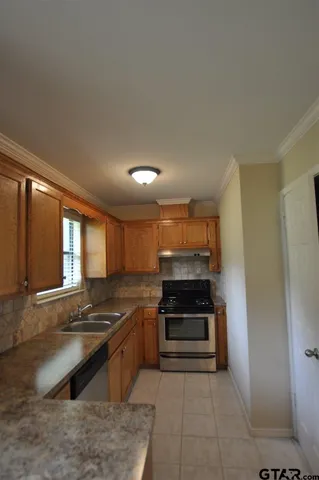 a kitchen with stainless steel appliances a stove and a refrigerator