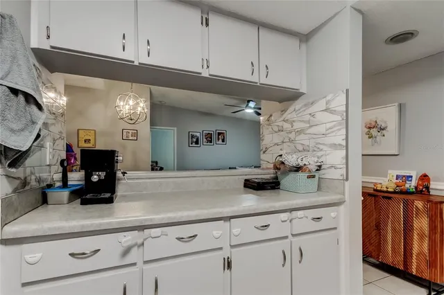 a kitchen with white cabinets and a sink