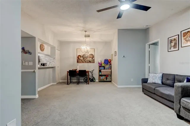 a living room with furniture and a chandelier