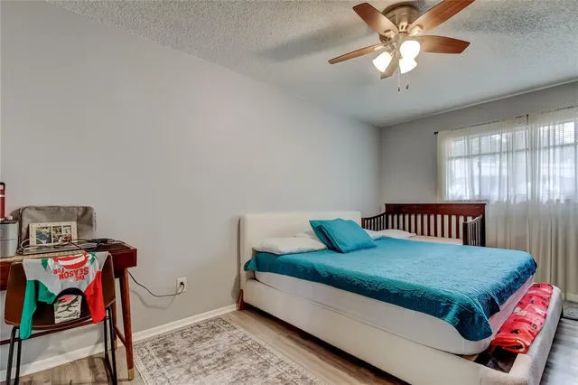 a bedroom with a bed a chandelier and closet