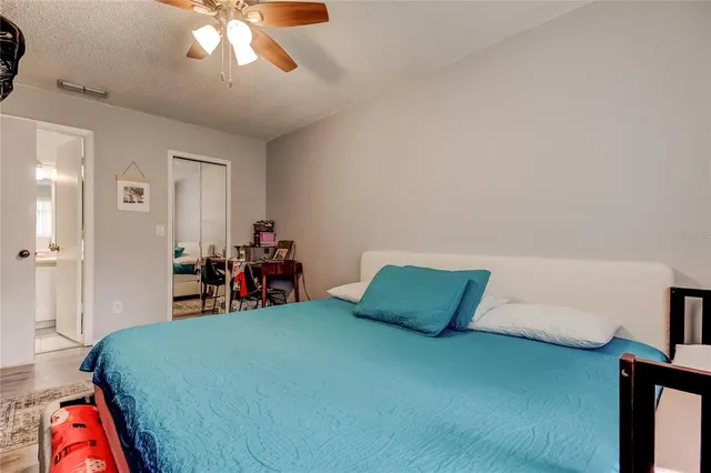 a bed room with a bed and a chandelier