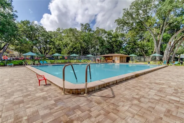 swimming pool view with a outdoor seating space