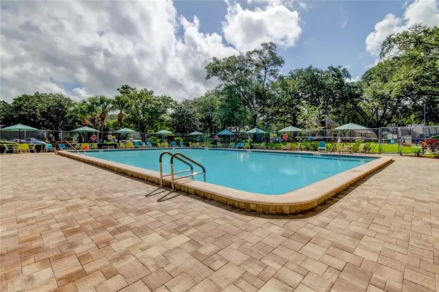 swimming pool view with a outdoor seating space