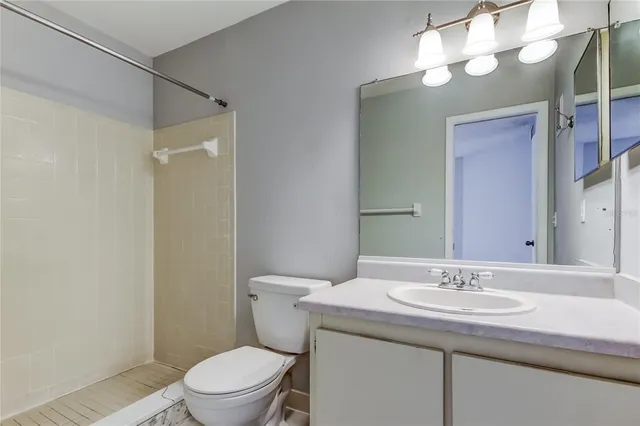 a view of empty room with wooden floor and window