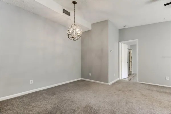 a view of empty room with wooden floor and window