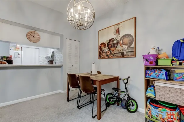 a view of a dining room with furniture and a kitchen