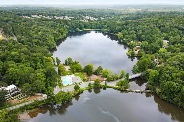 an aerial view of a house with a yard and lake view