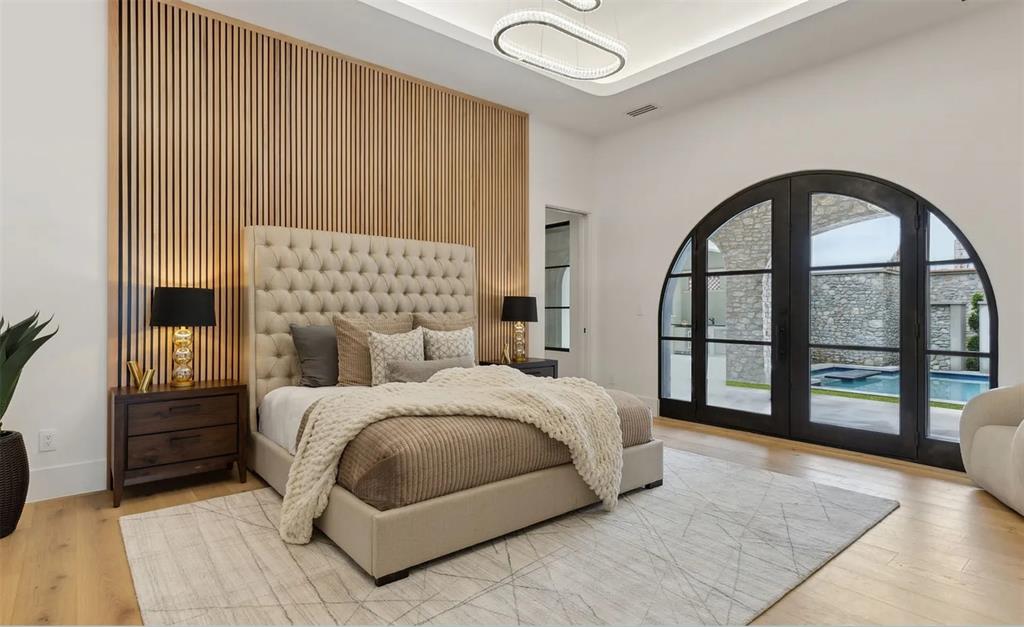 13713 Trail Creek Place Dallas, TX 75240 - Photo 6 of 15 a bedroom with a large bed and a large window