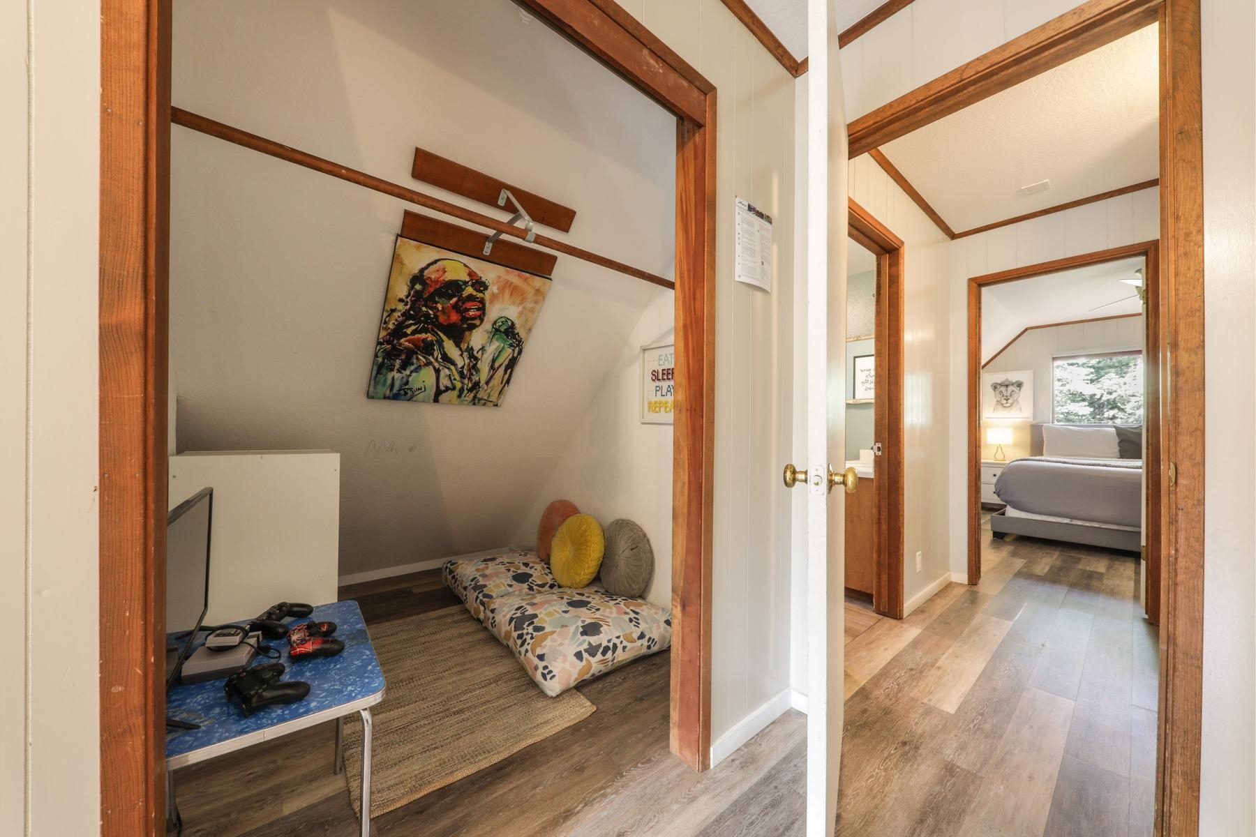 5656 Victoria Road Carnelian Bay, CA 96140 - Photo 22 of 28 a view of a hallway and a livingroom with wooden floor