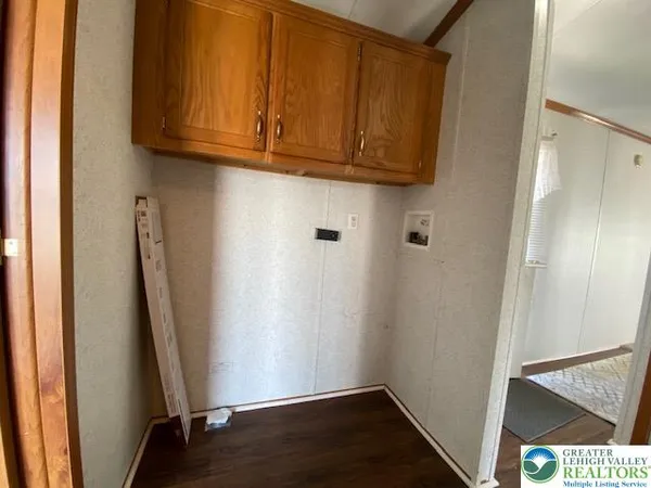 a view of storage and utility room with wooden floor