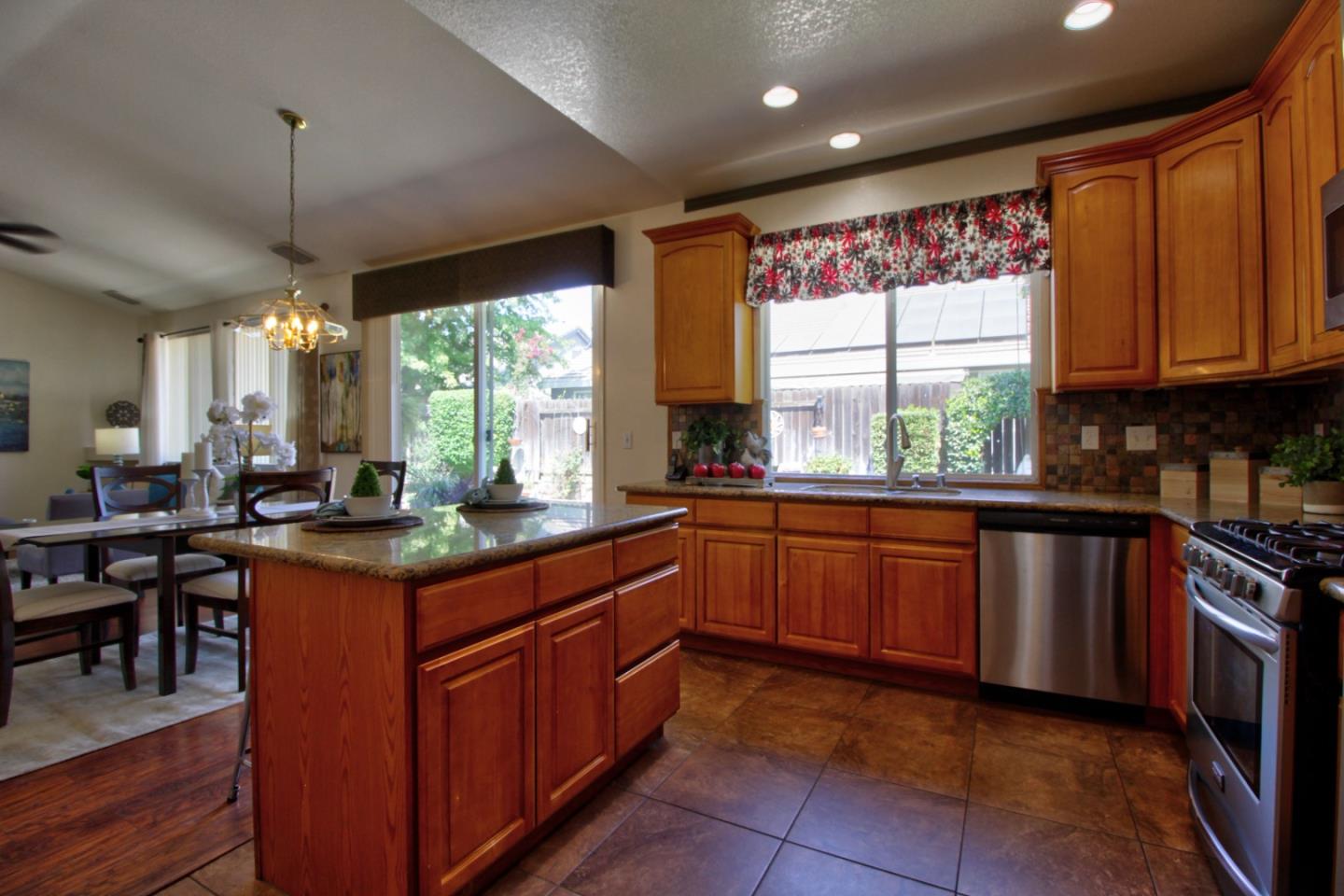 1833 Rail Street Manteca, CA 95337 - Photo 13 of 33 a kitchen with stainless steel appliances granite countertop counter space a sink and a window