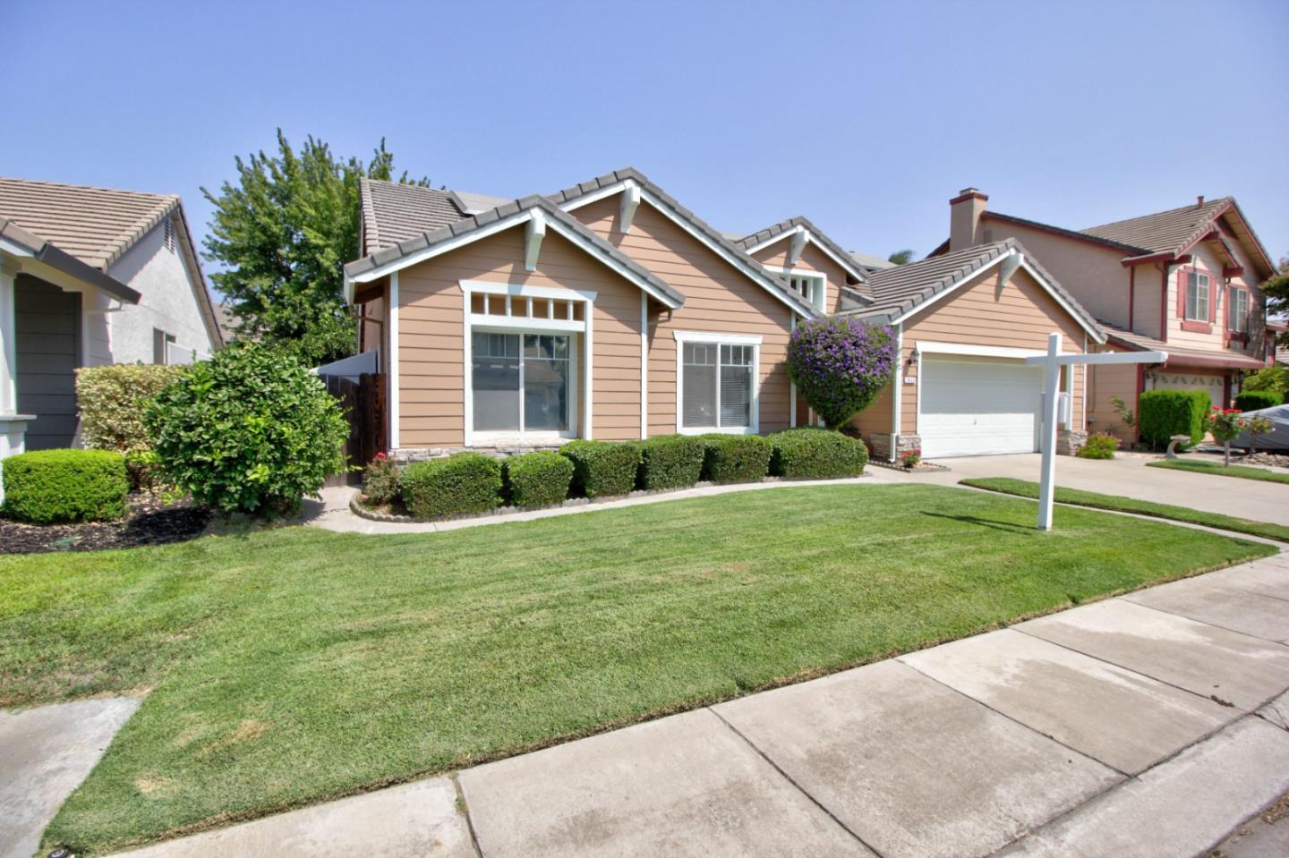 1833 Rail Street Manteca, CA 95337 - Photo 2 of 33 a front view of house with yard and green space
