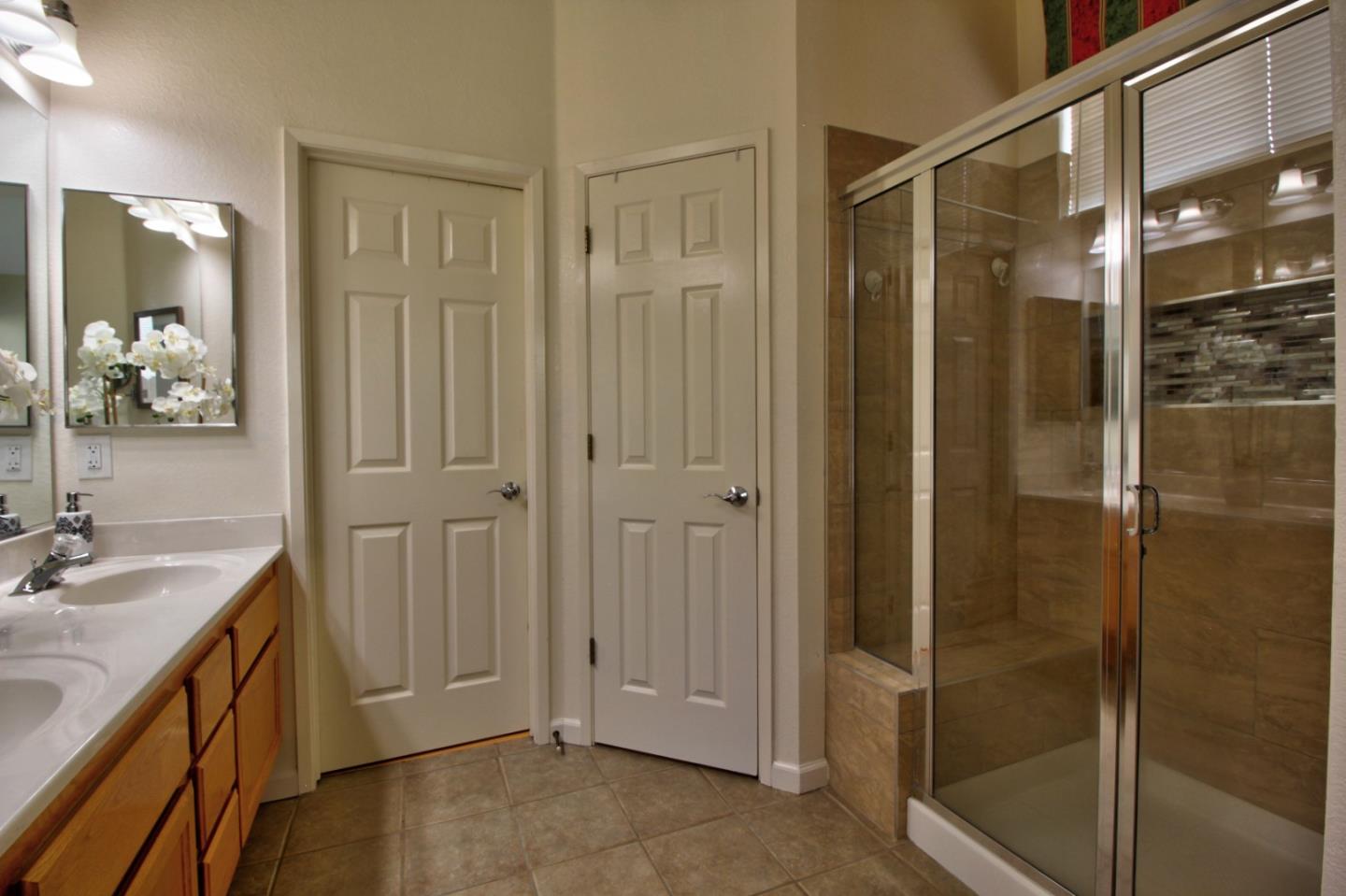 1833 Rail Street Manteca, CA 95337 - Photo 23 of 33 a bathroom with a shower sink and mirror