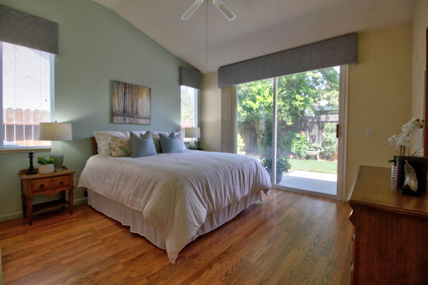 1833 Rail Street Manteca, CA 95337 - Photo 25 of 33 a bedroom with a bed and large windows
