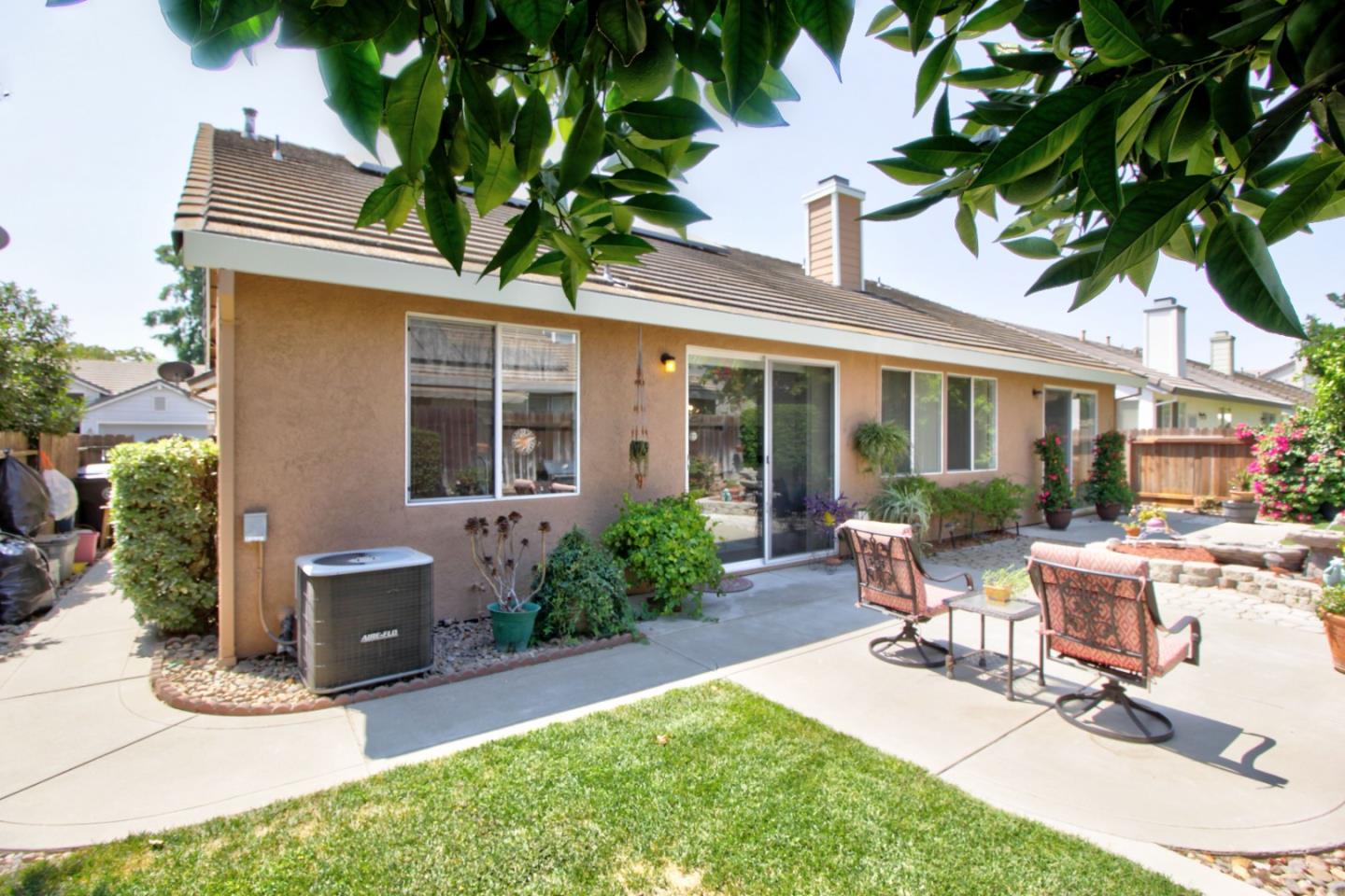 1833 Rail Street Manteca, CA 95337 - Photo 28 of 33 a view of a house with backyard sitting area and garden