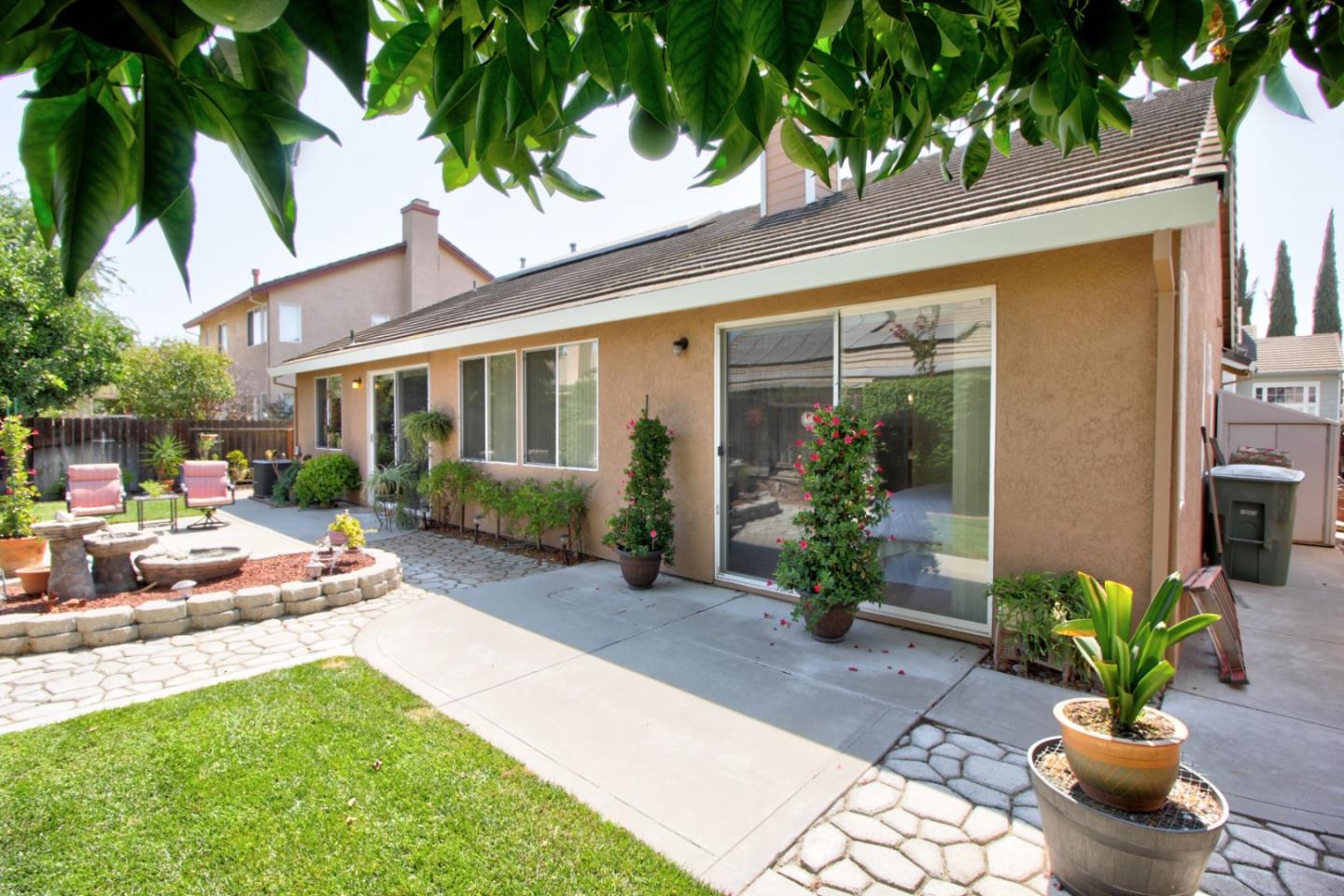 1833 Rail Street Manteca, CA 95337 - Photo 30 of 33 a view of a patio with table and chairs potted plants and floor to ceiling window