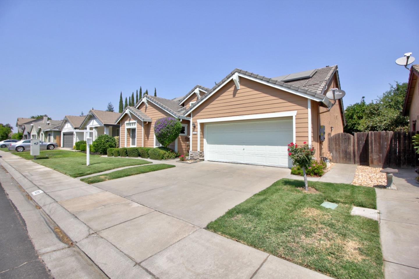1833 Rail Street Manteca, CA 95337 - Photo 3 of 33 a front view of a house with a yard and garage