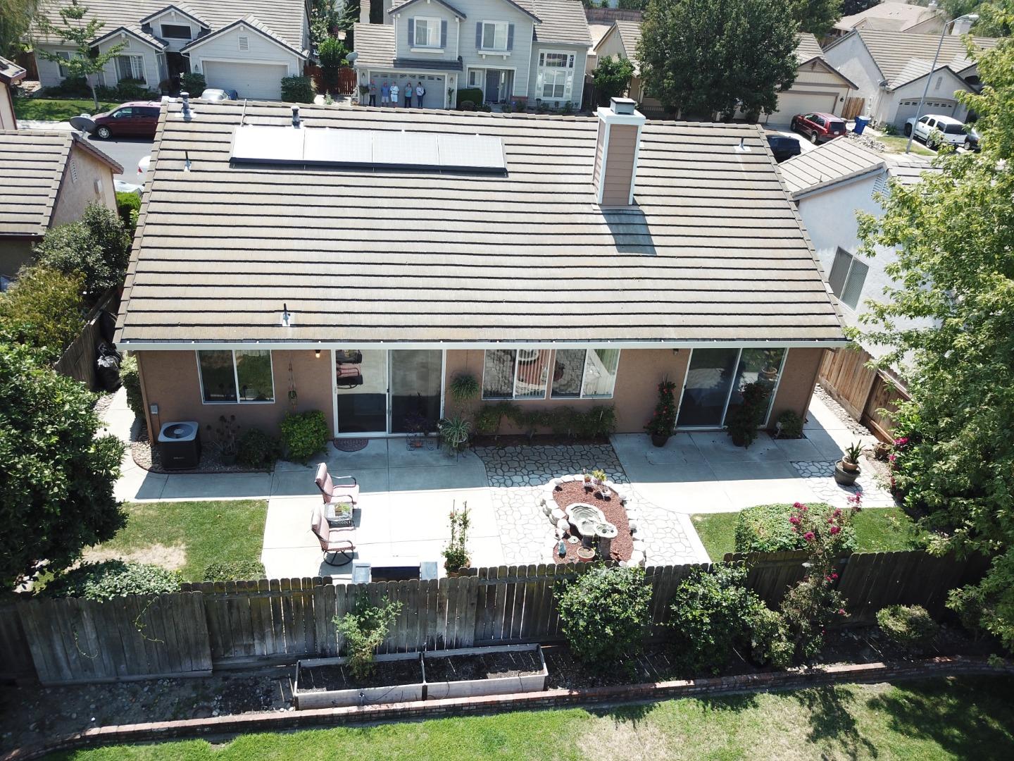 1833 Rail Street Manteca, CA 95337 - Photo 33 of 33 a view of a white house with a yard and potted plants