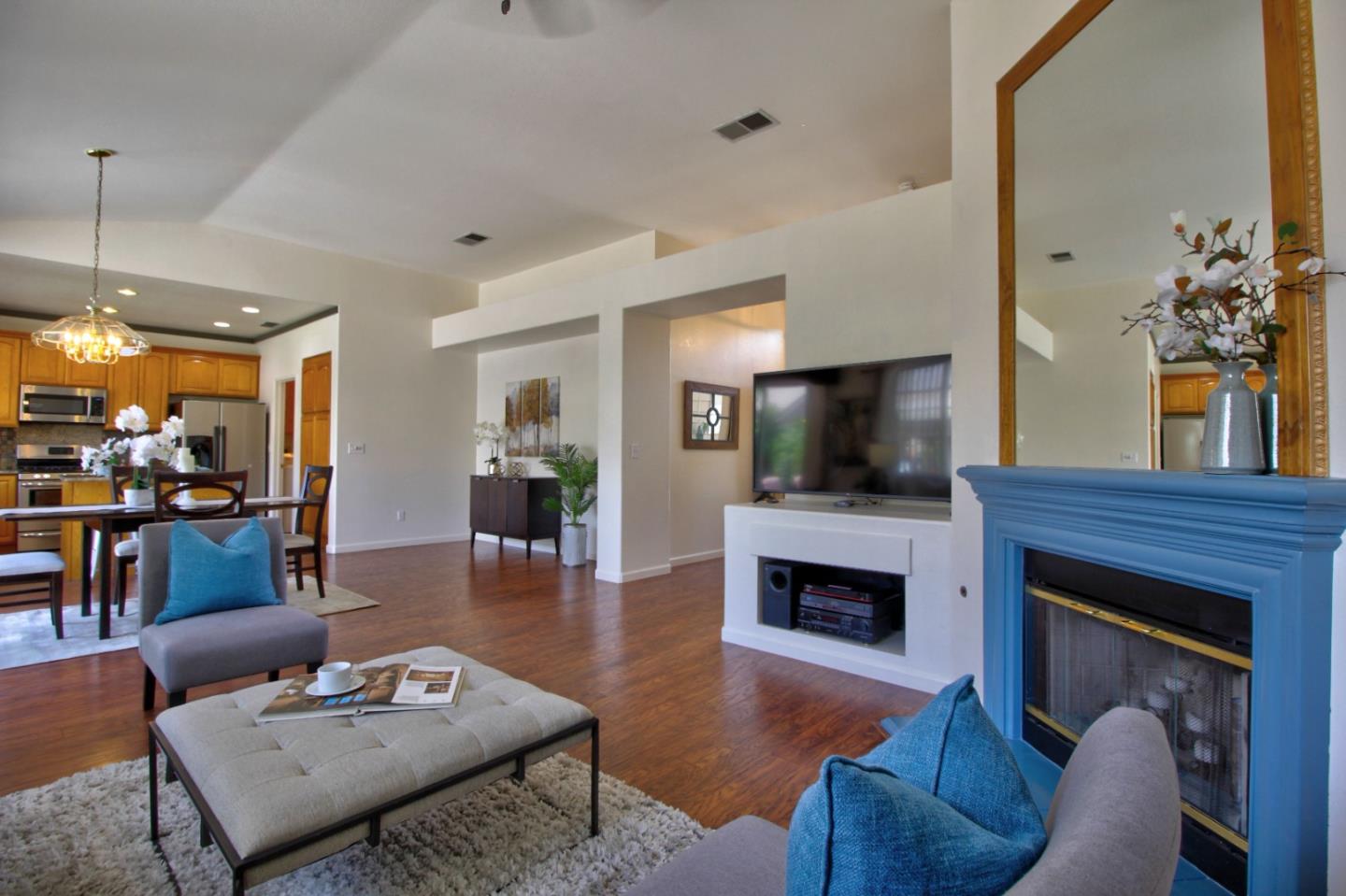 1833 Rail Street Manteca, CA 95337 - Photo 6 of 33 a living room with furniture a flat screen tv and a fireplace