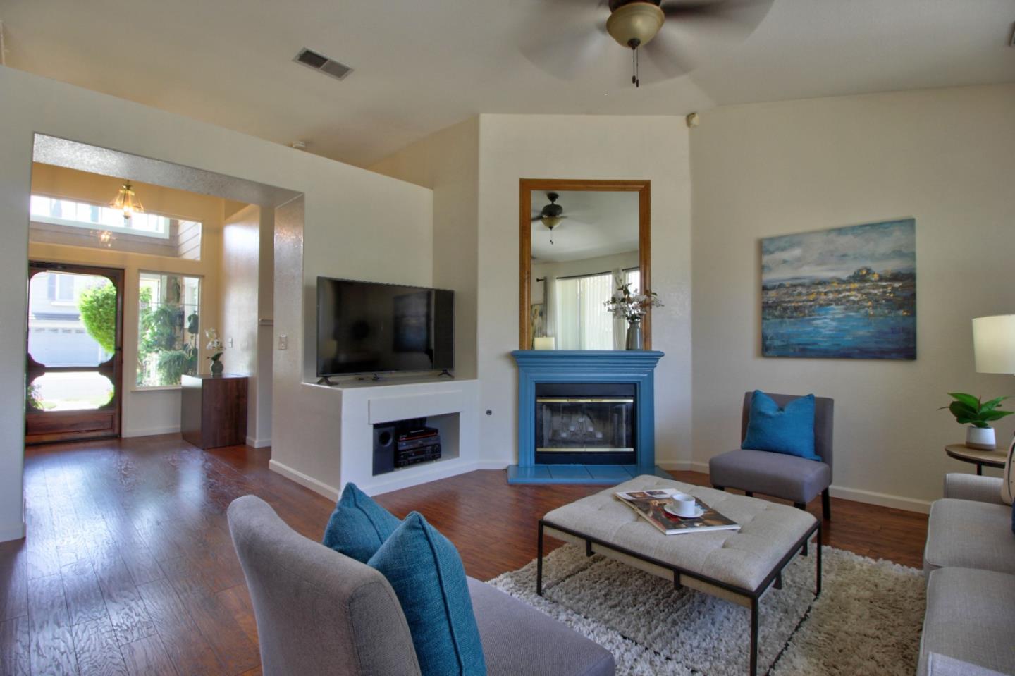 1833 Rail Street Manteca, CA 95337 - Photo 9 of 33 a living room with furniture a flat screen tv and a fireplace