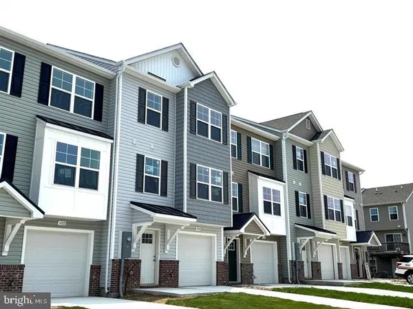 a front view of a residential apartment building with a yard