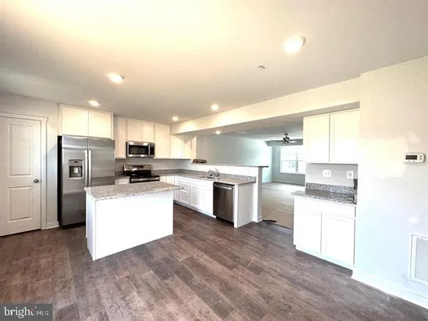 a kitchen with refrigerator and cabinets