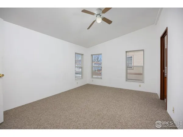 a view of empty room with ceiling fan