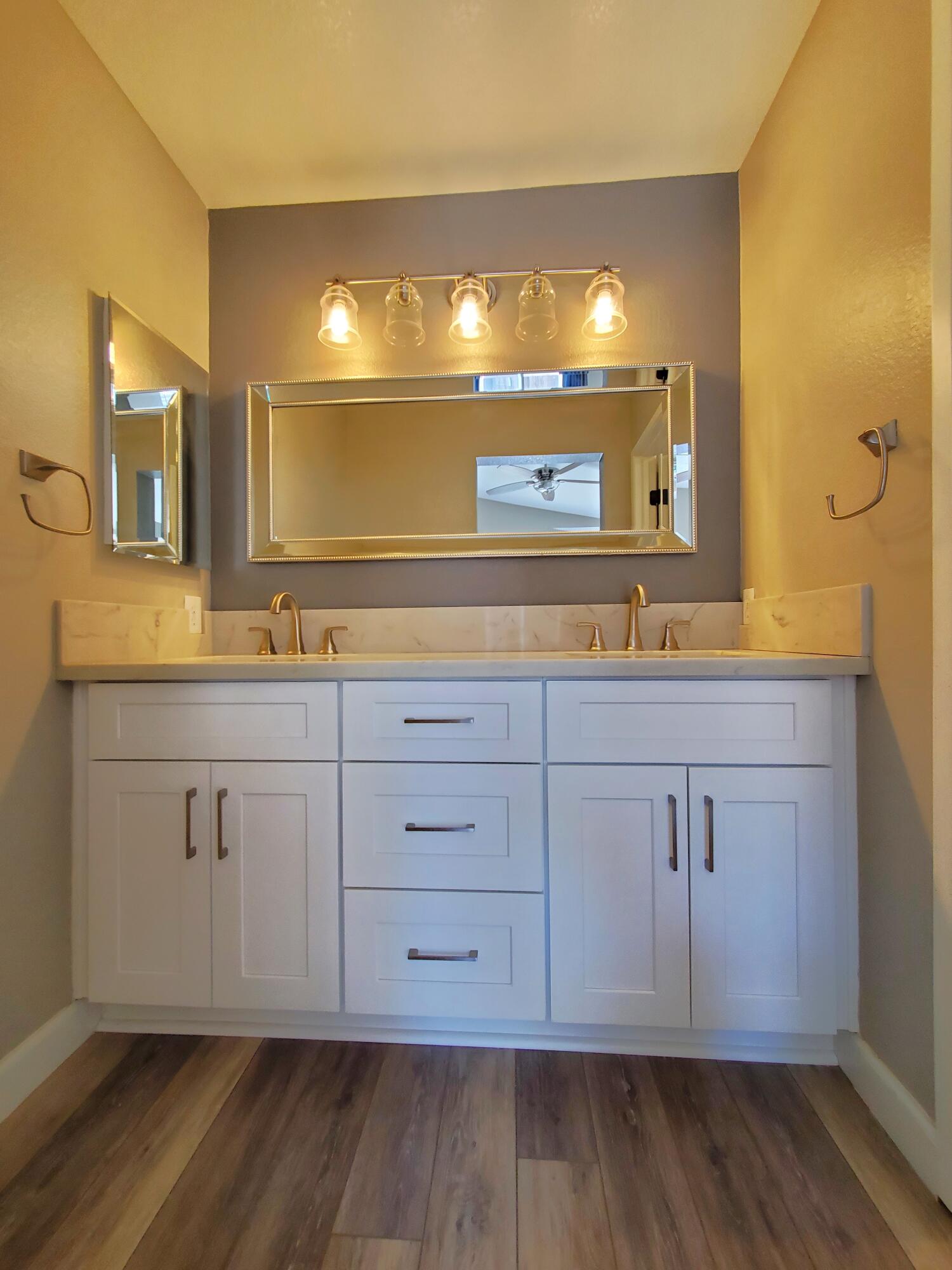 5260 Melbourne Place Riverside, CA 92508 - Photo 17 of 26 a view of a double vanity sink mirror and cabinets