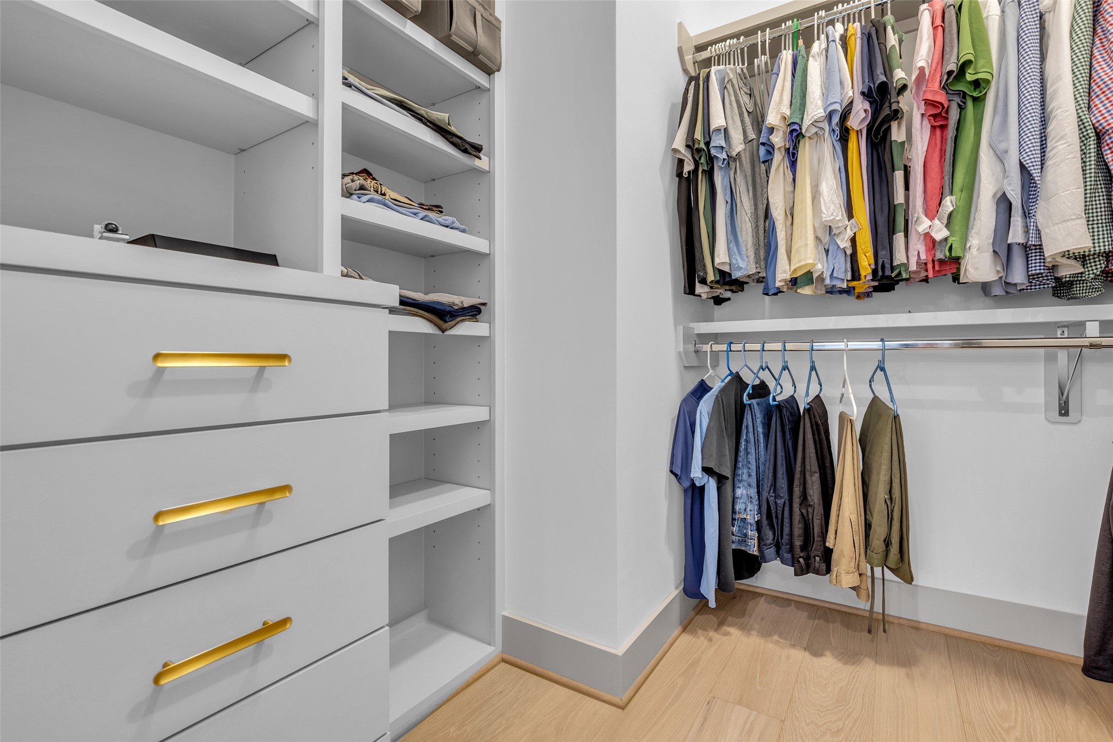1724 Ridgewood Street Houston, TX 77006 - Photo 22 of 38 The primary bedroom also includes a walk-in closet with built-in shelves and hanging racks, providing convenient storage and organization for your wardrobe and belongings.