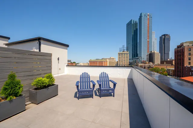 a terrace with outdoor seating and city view