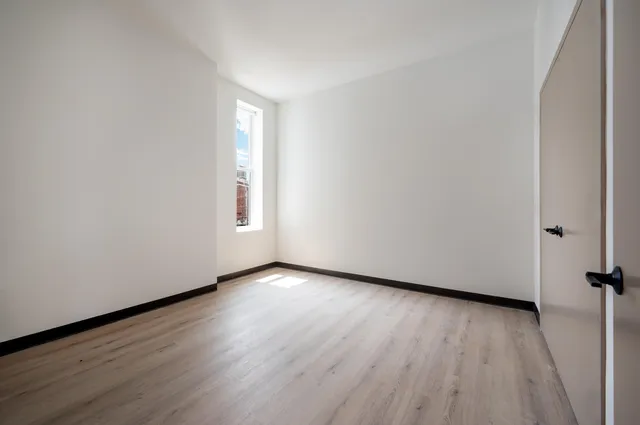 a view of an empty room and wooden floor