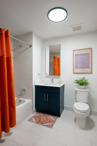 a bathroom with a sink a toilet and bathtub
