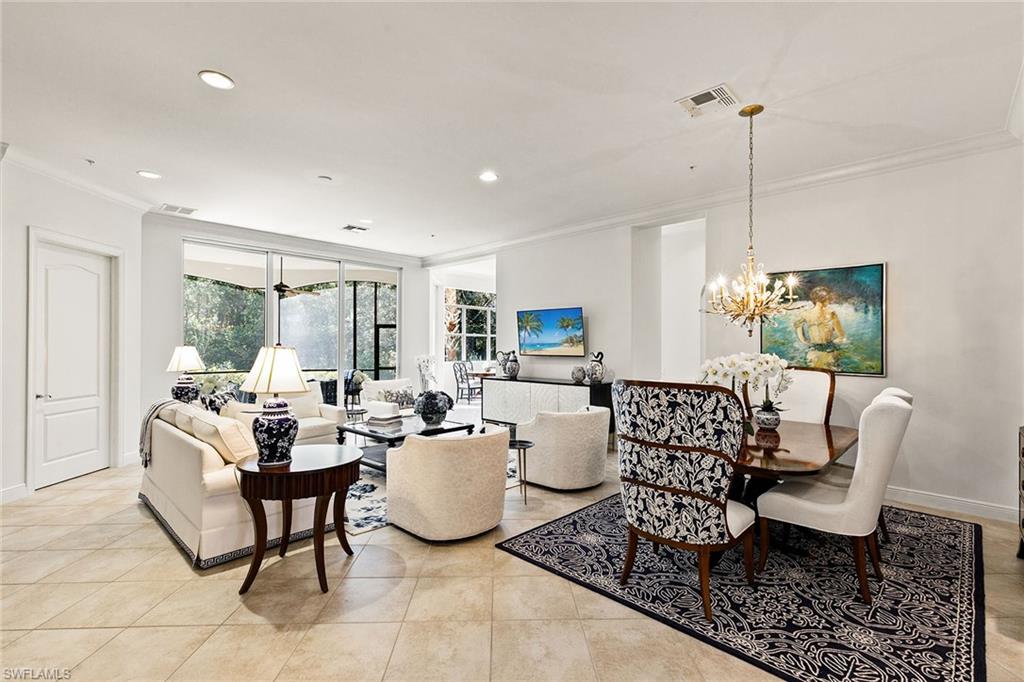 28540 Calabria Court, Unit 102 Naples, FL 34110 - Photo 11 of 32 a living room with furniture a window and a table