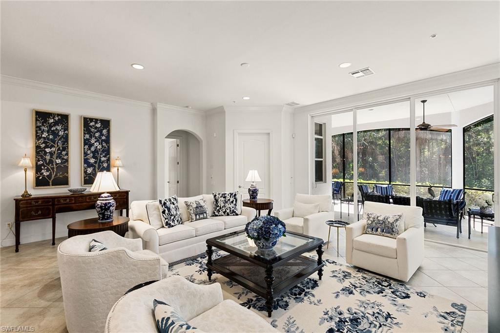 28540 Calabria Court, Unit 102 Naples, FL 34110 - Photo 13 of 32 a living room with furniture and large windows