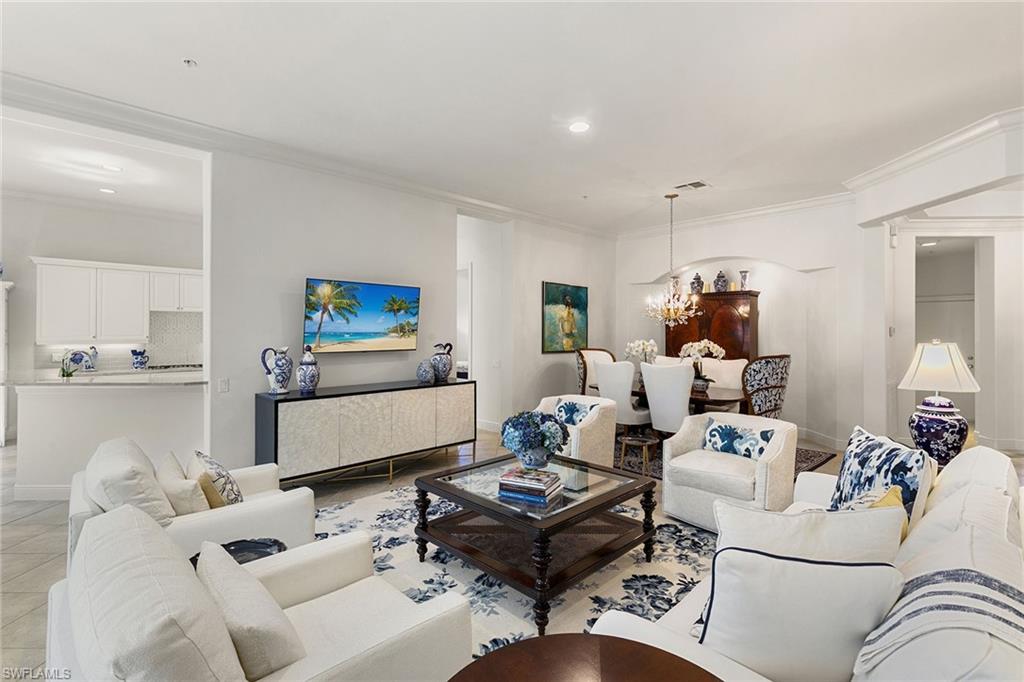 28540 Calabria Court, Unit 102 Naples, FL 34110 - Photo 15 of 32 a living room with furniture and a table