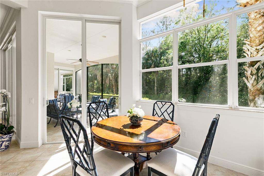 28540 Calabria Court, Unit 102 Naples, FL 34110 - Photo 20 of 32 a view of a dining room with furniture window and outside view