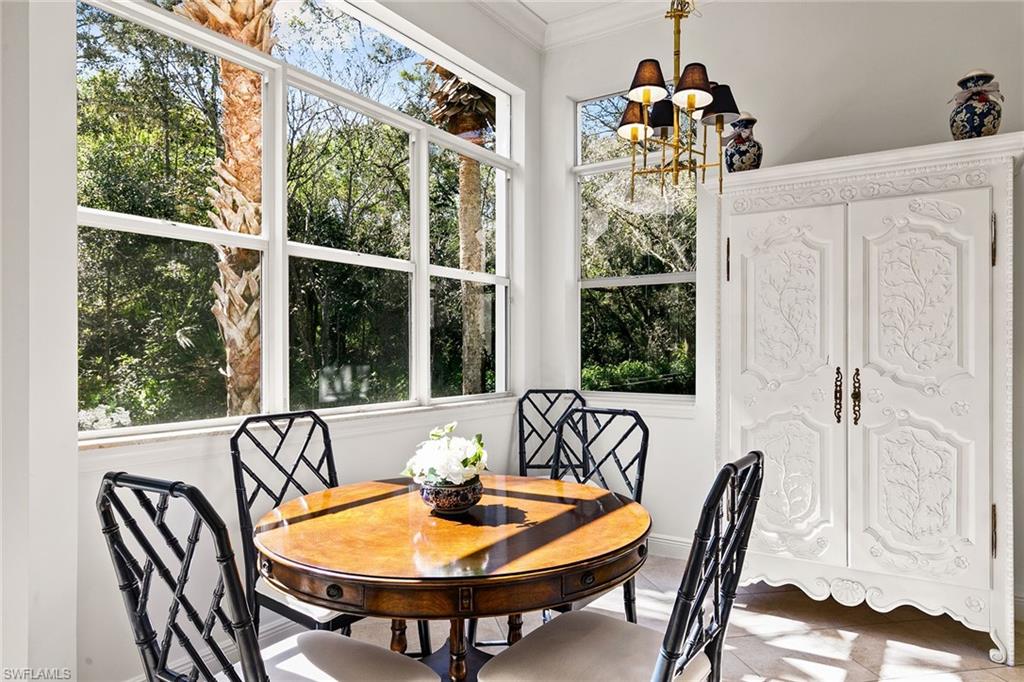 28540 Calabria Court, Unit 102 Naples, FL 34110 - Photo 21 of 32 a dining room with furniture and window