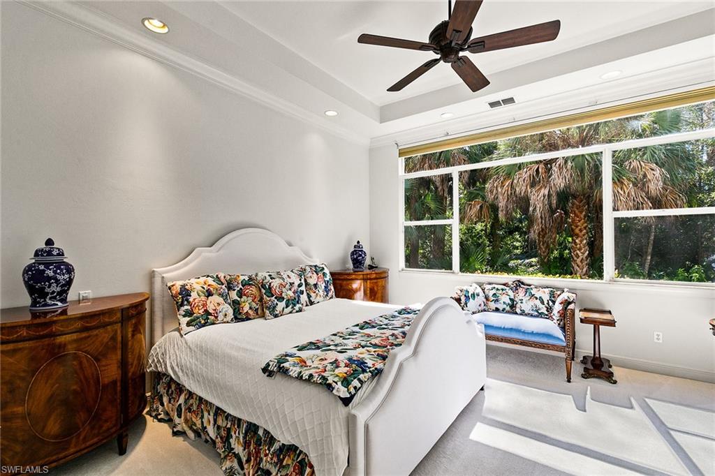 28540 Calabria Court, Unit 102 Naples, FL 34110 - Photo 22 of 32 a bed sitting in a bedroom next to a window