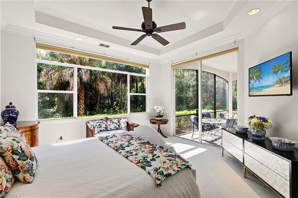 28540 Calabria Court, Unit 102 Naples, FL 34110 - Photo 23 of 32 a bed room with a bed and a couch